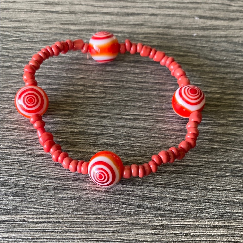 Handmade never worn burnt orange bracelet with blown glass.